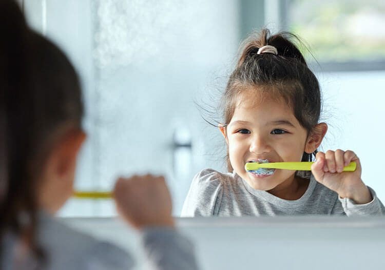 Young Girl Brushing Teeth