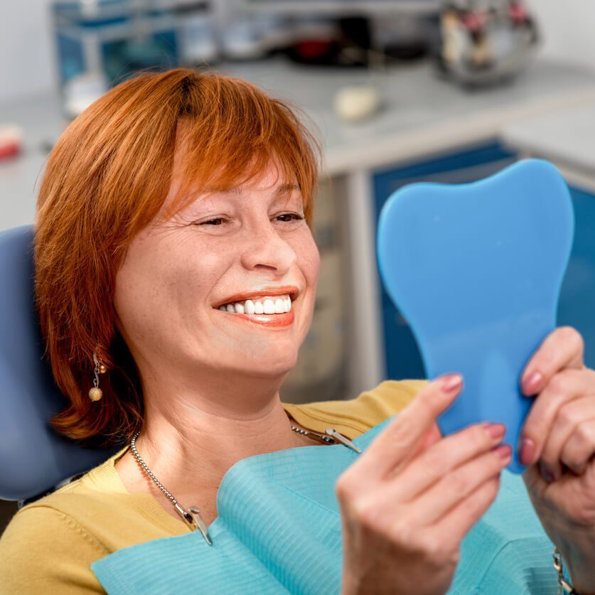 red haired woman in dental office